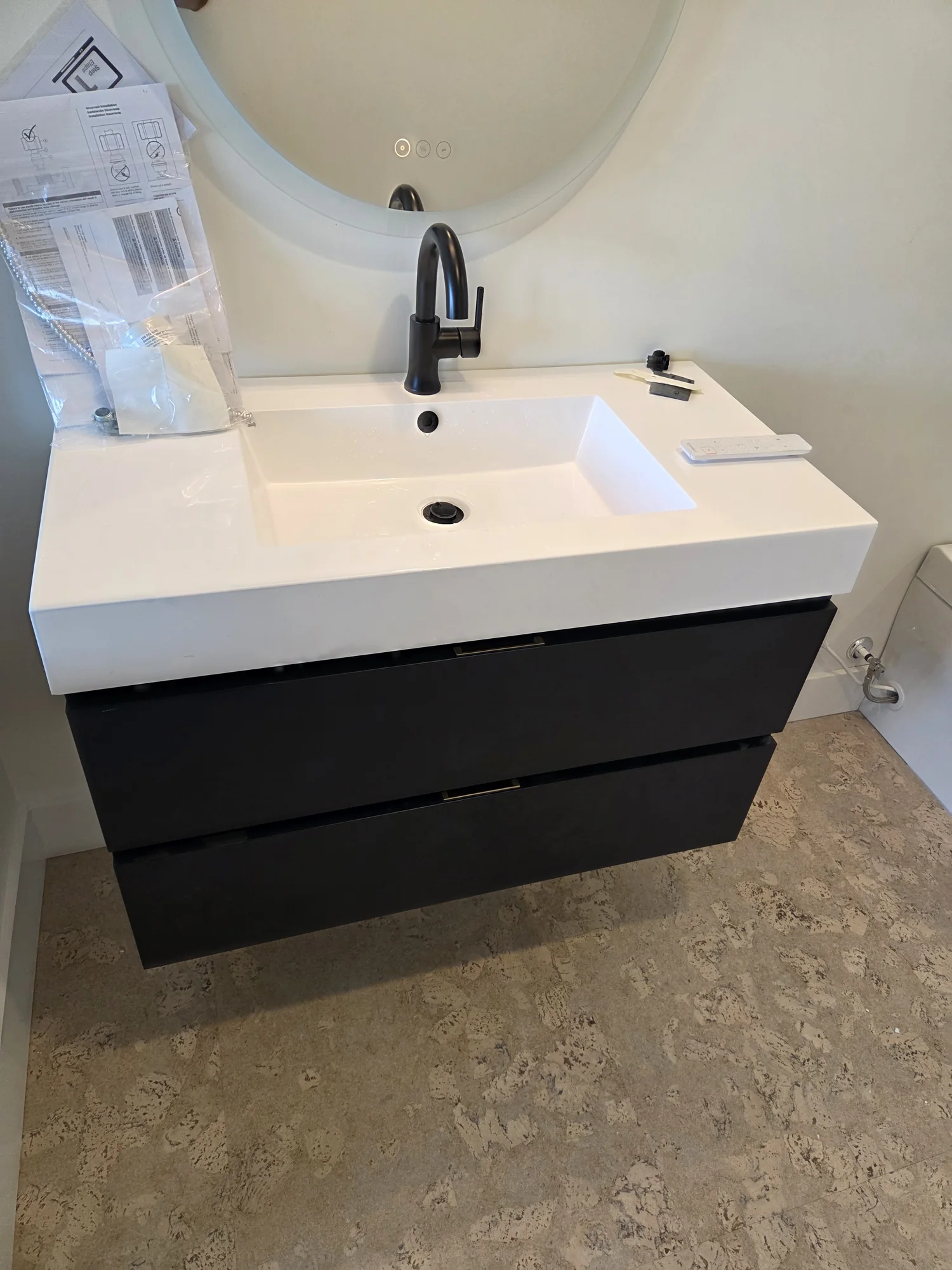 Floating bathroom vanity with a black faucet