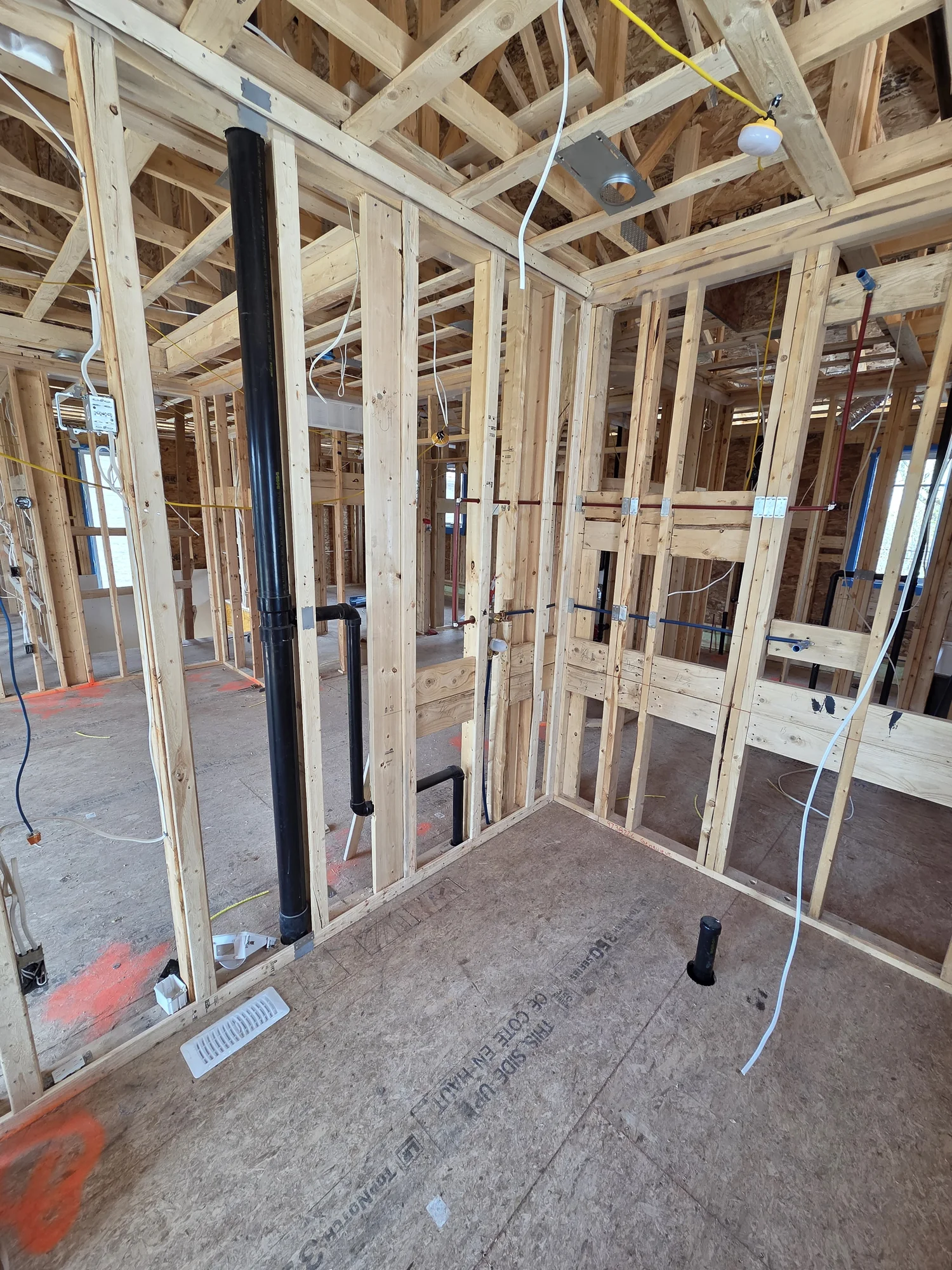Plumbing rough-in within the timber framing of a new home