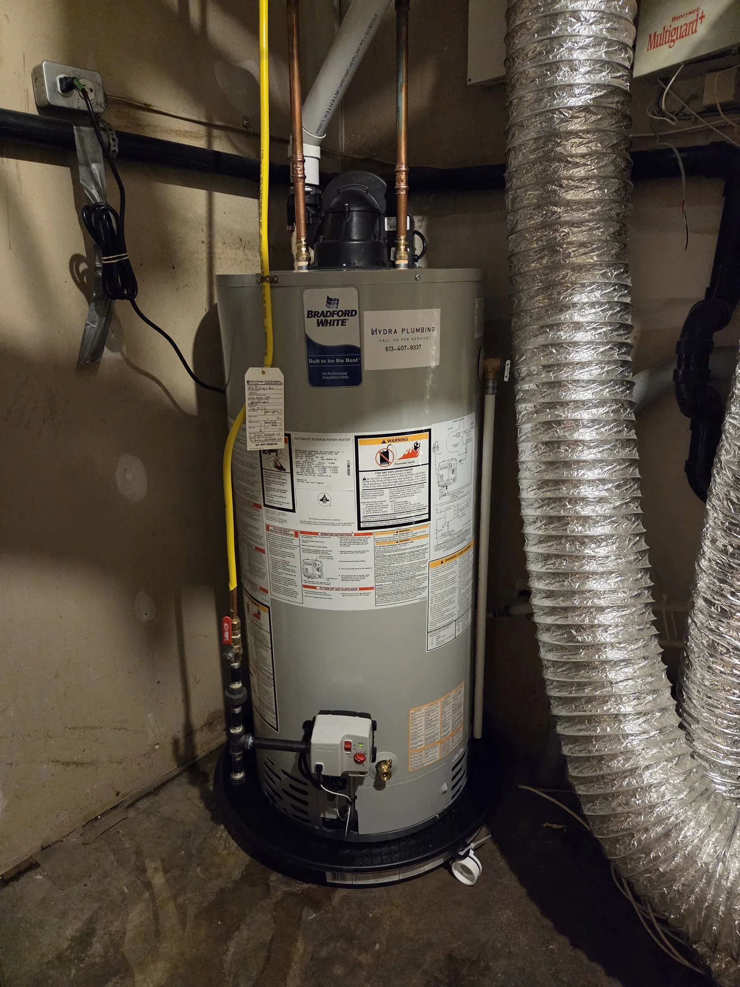 Power-vent gas water heater in a basement mechanical space