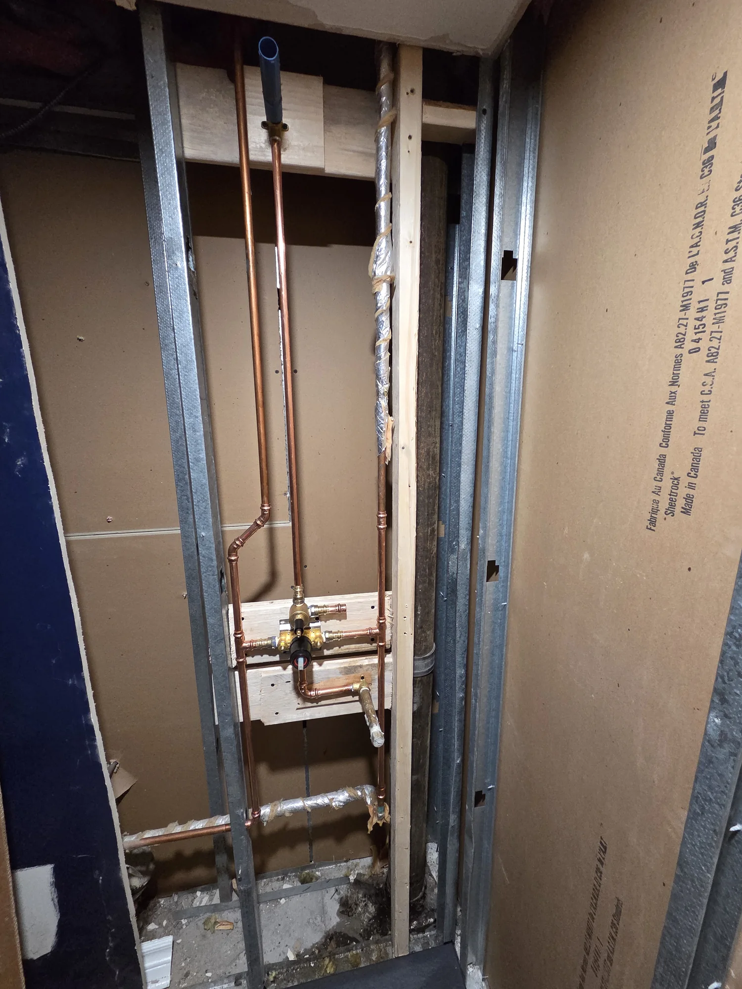 Copper shower valve assembly in exposed wall framing