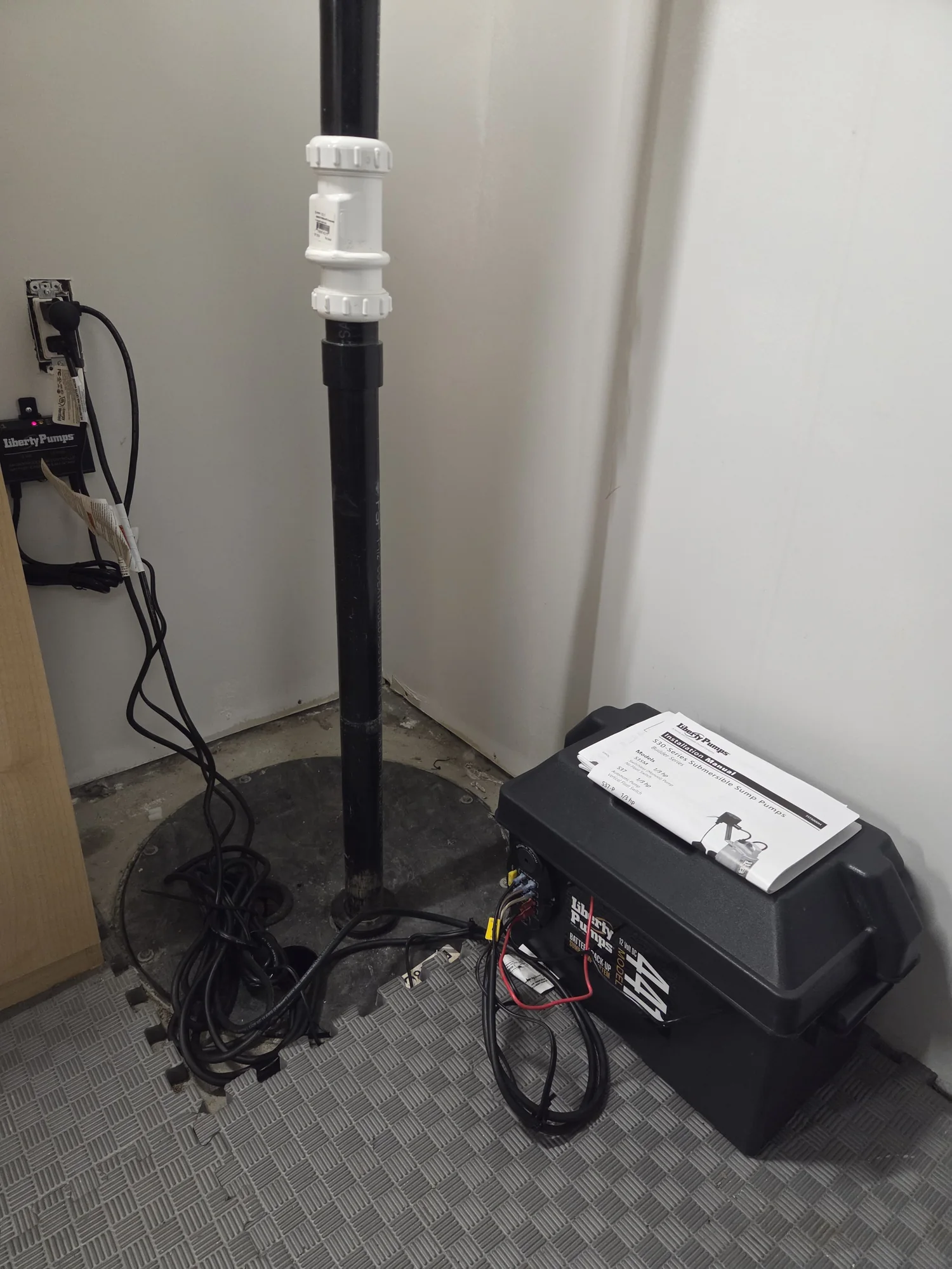 Sump pump discharge pipe and battery backup system