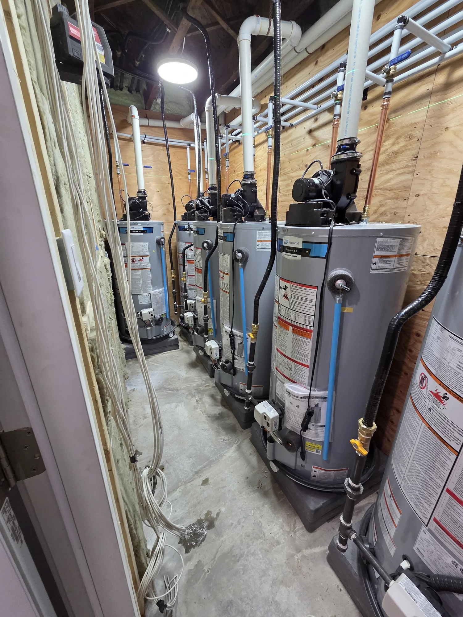 Row of water heaters with individual water connections