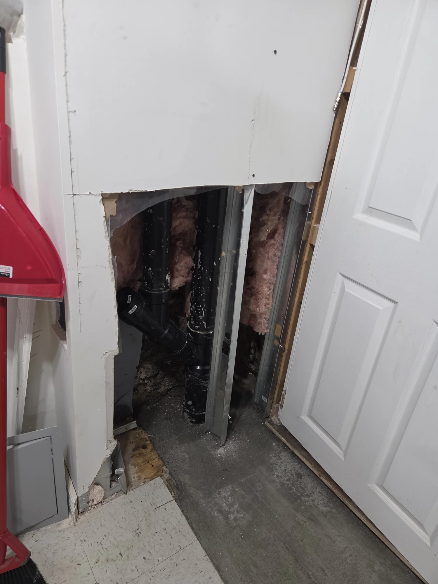 Wall opening giving access to water-meter plumbing