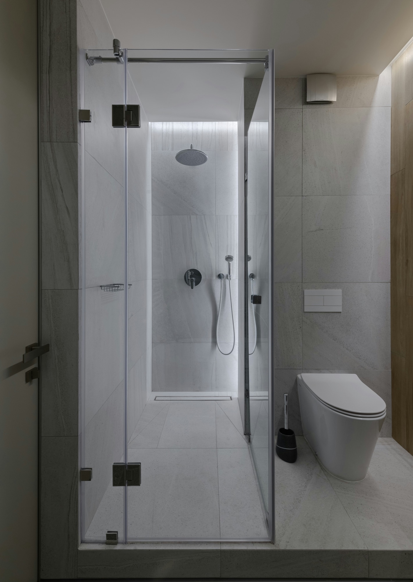 Modern finished bathroom with a glass shower and wall-hung toilet