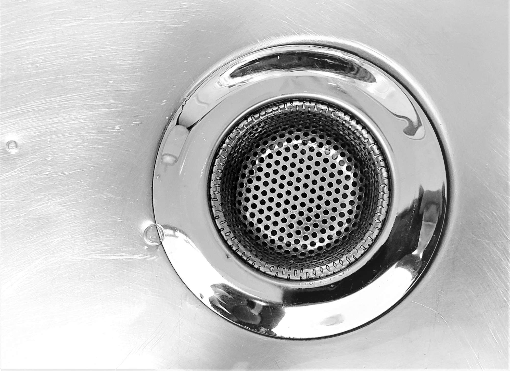 Close-up of a stainless-steel kitchen sink drain strainer