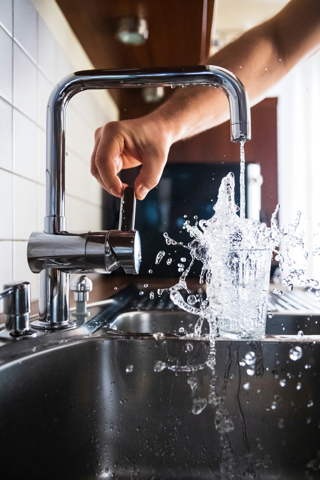 Water splashing from a modern kitchen faucet